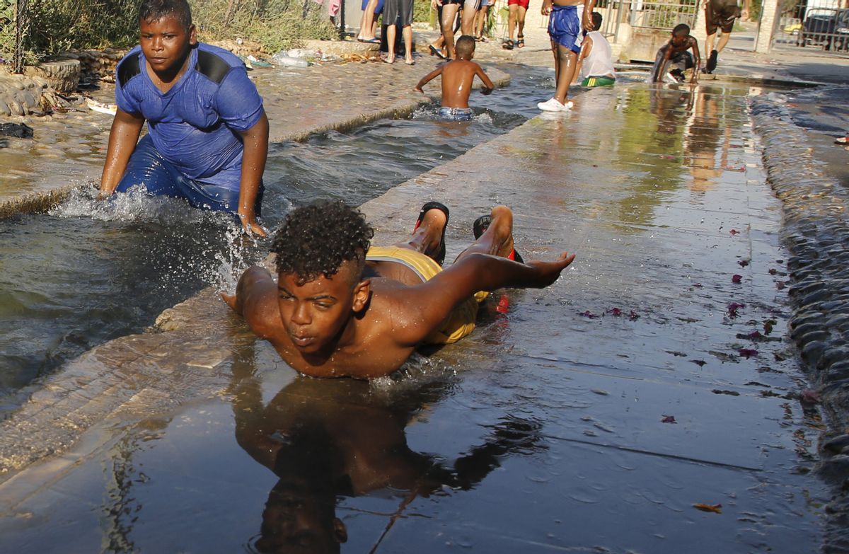 Palestinian children swim in an irrigation canal in the village of Ain al-Sultan, northwest of the West Bank city of Jericho, on July 21, 2019.  (JAAFAR ASHTIYEH/AFP/Getty Images)